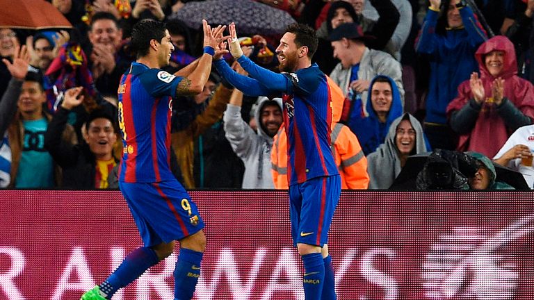 Lionel Messi celebrates his goal against Sevilla with team-mate Luis Suarez