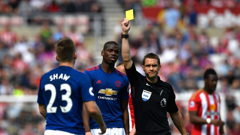 SUNDERLAND, ENGLAND - APRIL 09:  Referee Craig Pawson shows the yellow card to Luke Shaw of Manchester United during the Premier League match between Sunde