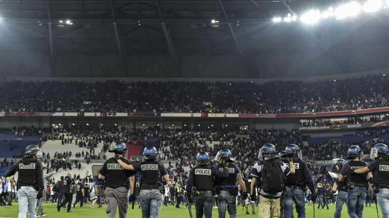 Police stand on the pitch after Besiktas' and Lyon's supporters fought before the Europa League quarter-final