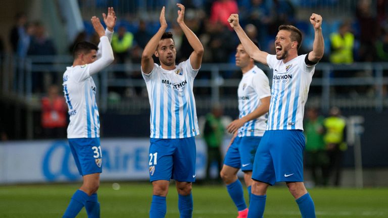 Malaga's players celebrates after winning 2-0 the Spanish league football match Malaga CF vs FC Barcelona at La Rosaleda stadium in Malaga on April 8, 2017