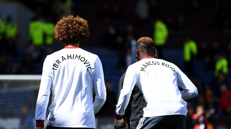 Paul Pogba and Marouane Fellaini of Manchester United wear shirts displaying the names of team-mates Marcos Rojo and Zlatan Ibrahimovic