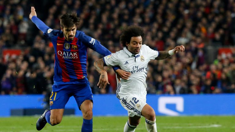 Real Madrid's Portuguese defender Marcelo Vieira (R) vies with Barcelona's Portuguese midfielder Andre Gomes during the Spanish league football match FC Ba