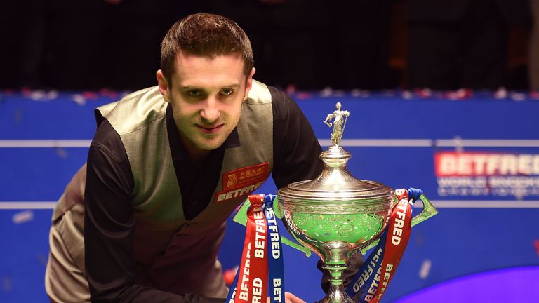 England's Mark Selby poses with the trophy after beating China's Ding Junhui in the final of the World Snooker Championship at the Crucible