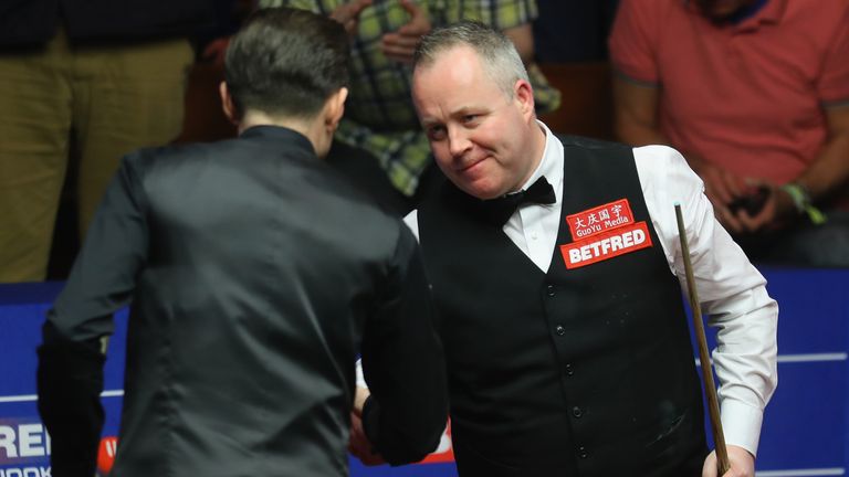  John Higgins of Scotland shakes hands with Mark Selby 