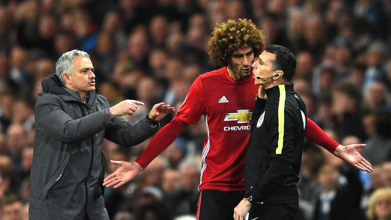 Marouane Fellaini protests his dismissal to the fourth official