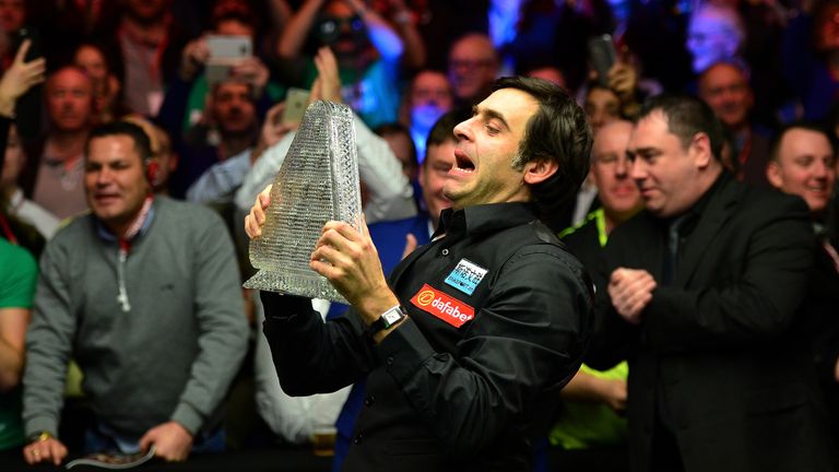 Ronnie O'Sullivan celebrates with the Dafabet Masters Trophy after defeating Barry Hawkins