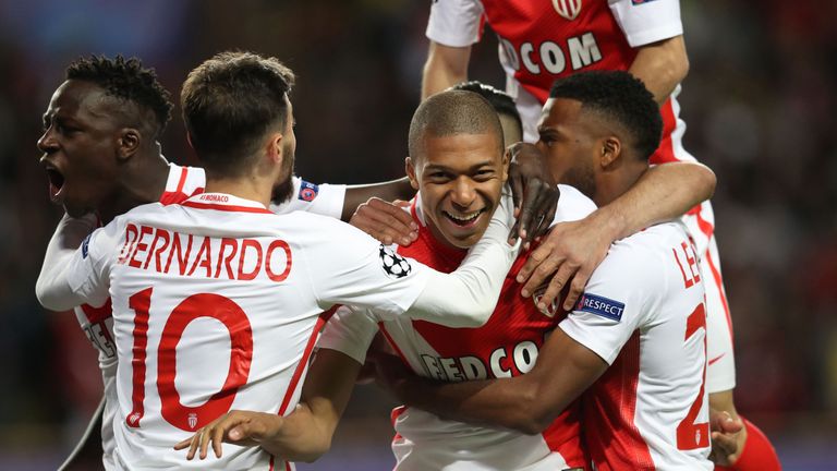Monaco's French forward Kylian Mbappe Lottin  (C-R) and teammates celebrate after Mbappe opened the scoring during the UEFA Champions League 2nd leg quarte