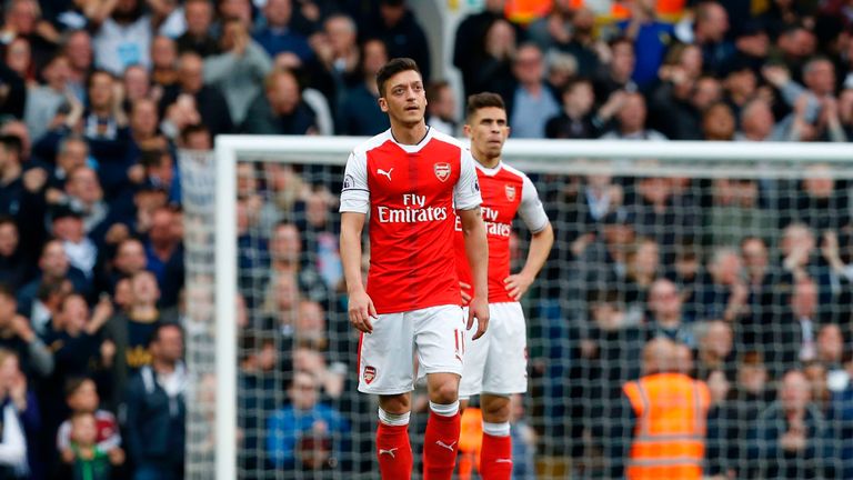 Arsenal's German midfielder Mesut Ozil (L) and Arsenal's Brazilian defender Gabriel react to the first goal by Tottenham Hotspur's English midfielder Dele 