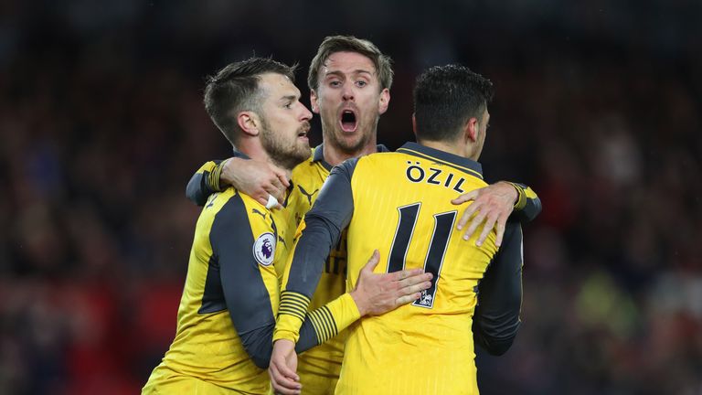 MIDDLESBROUGH, ENGLAND - APRIL 17:  Mesut Ozil of Arsenal (11) celebrates as he scores their second goal with Aaron Ramsey (L) and Nacho Monreal (C)  durin