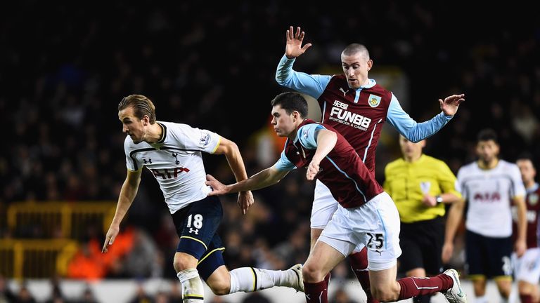 Michael Keane tries to stop Tottenham's Harry Kane in his tracks
