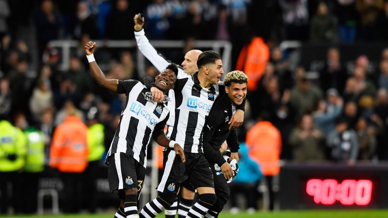 Christian Atsu, Ayoze Perez and DeAndre Yedlin of Newcastle United celebrate victory and promotion