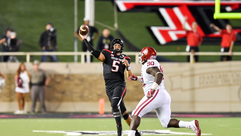 LUBBOCK, TX - OCTOBER 22: Patrick Mahomes II #5 of the Texas Tech Red Raiders passes the ball under pressure from Neville Gallimore #90 of the Oklahoma Soo