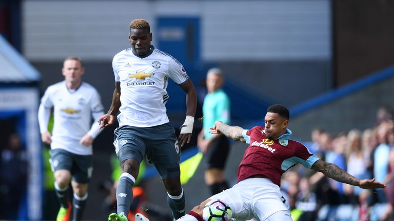 Paul Pogba takes on Andre Gray in the early stages at Turf Moor