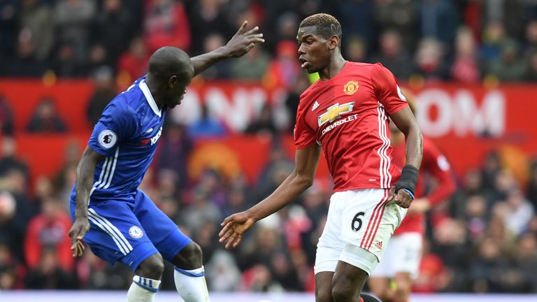 MANCHESTER, ENGLAND - APRIL 16: N'Golo Kante of Chelsea tackles Paul Pogba of Manchester United during the Premier League match between Manchester United a