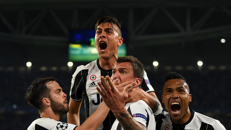 Paulo Dybala of Juventus celebrates with Miralem Pjanic, Mario Mandzukic and Alex Sandro of Juventus after scoring against Barcelona