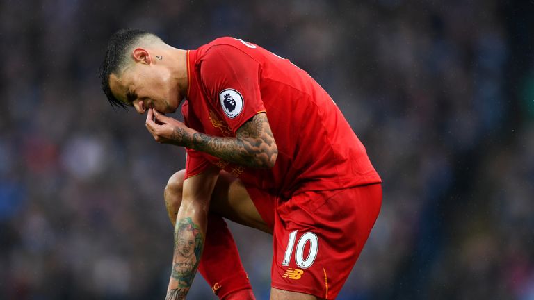 Philippe Coutinho of Liverpool goes down injured and holds his mouth during the Premier League match between Manchester Ci