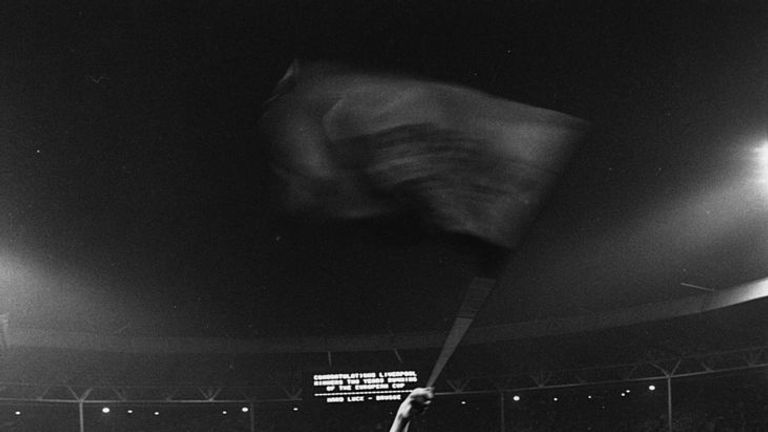 Liverpool defender Phil Thompson waves a flag in triumph after beating Bruges 1-0 in the final at Wembley Stadium.