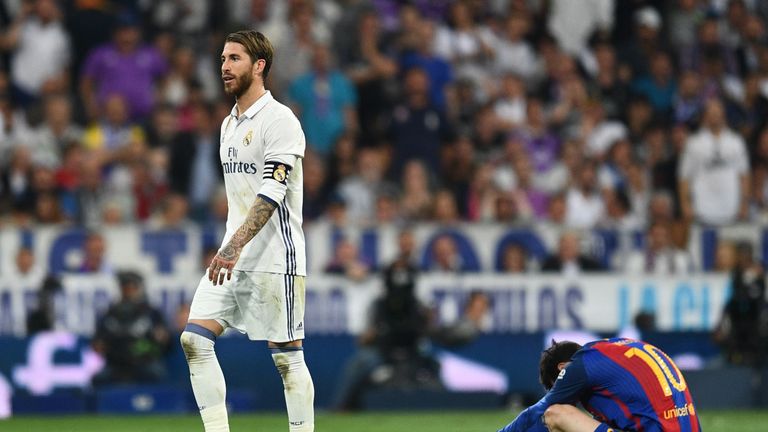 Sergio Ramos walks past Messi  as he is sent off