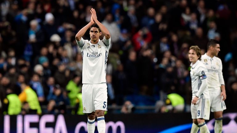 Real Madrid's French defender Raphael Varane claps at the end of the UEFA Champions League round of 16 first leg football match Real Madrid CF vs SSC Napol