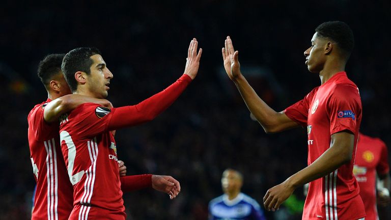 Manchester United's Armenian midfielder Henrikh Mkhitaryan (L) high-fives with Manchester United's English striker Marcus Rashford (R) after scoring the op