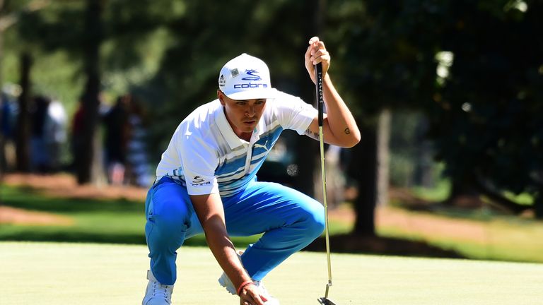 Rickie Fowler of the United States lines up a putt on the first hole during the third round of the 2017 Masters Tournament at Augu