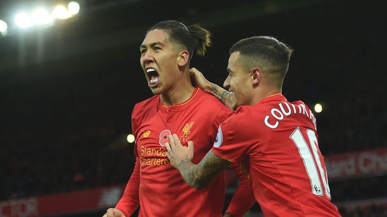 Liverpool's Roberto Firmino (left) celebrates a goal with Philippe Coutinho