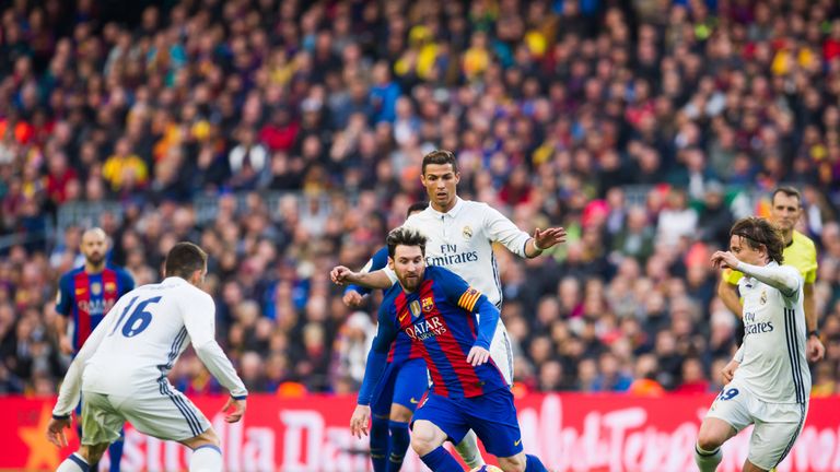 BARCELONA, SPAIN - DECEMBER 03:  Lionel Messi (C) of FC Barcelona conducts the ball between Mateo Kovacic (L), Cristiano Ronaldo (2nd R) and Luka Modric (R