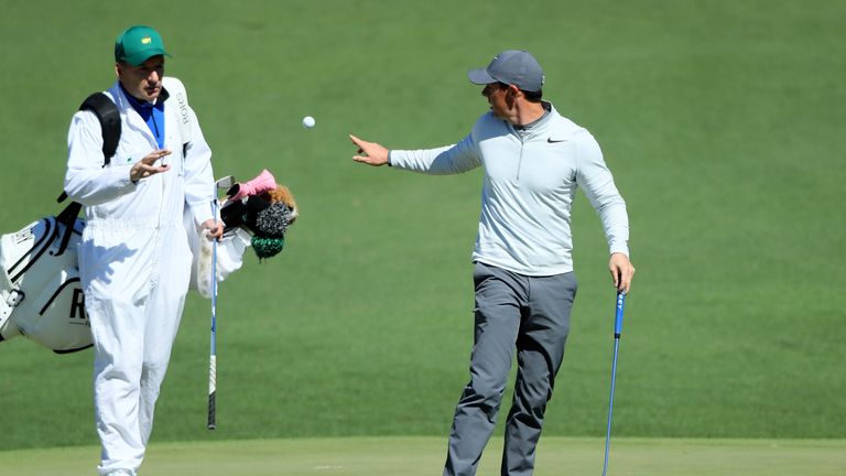 Rory McIlroy of Northern Ireland tosses a golf ball to JP Fitzgerald on the second hole during the second round of the 2017 Masters