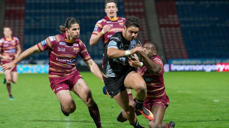 Brayden Wiliame breaks the tackles of Huddersfield's Jake Mamo and Jermaine McGillvary to score a try