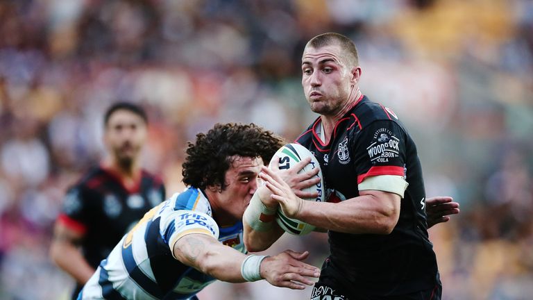 Kieran Foran beats the tackle from Kevin Proctor of the Titans