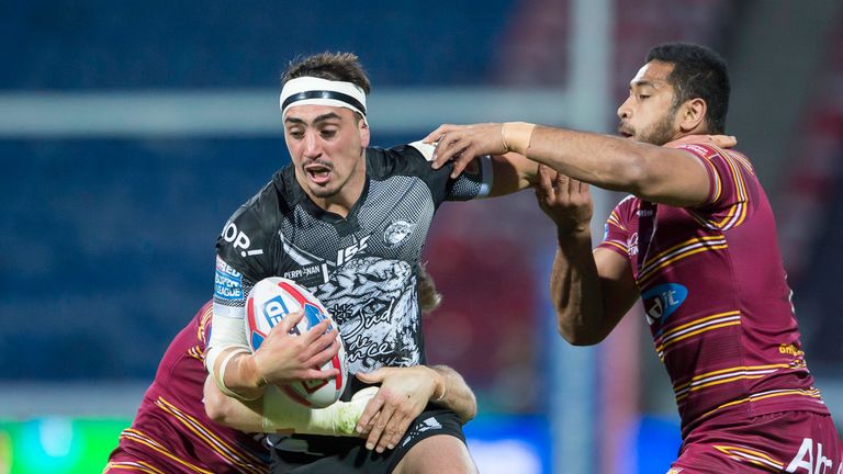 Tony Gigot is tackled by Huddersfield's Sebastine Ikahihifo