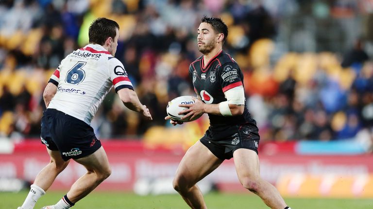 Shaun Johnson runs the ball against Luke Keary of Sydney Roosters