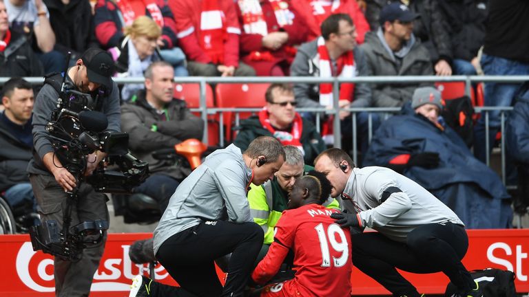 Sadio Mane of Liverpool receives treatment from the medical team during the Merseyside derby