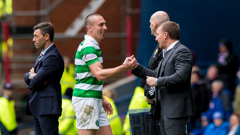 Celtic manager Brendan Rodgers congratulates Scott Brown as he is substituted at Ibrox (1-5 game)