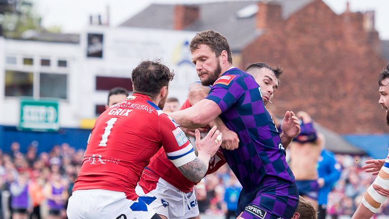 Wigan's Sean O'Loughlin powers through the Wakefield defence to score a try.