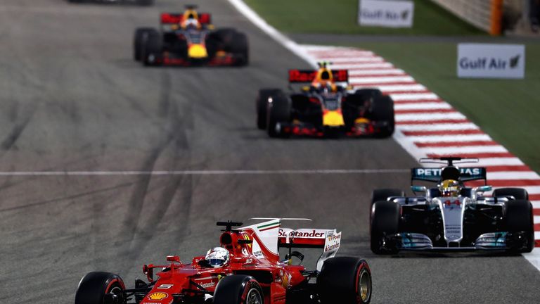 BAHRAIN, BAHRAIN - APRIL 16: Sebastian Vettel of Germany driving the (5) Scuderia Ferrari SF70H leads Lewis Hamilton of Great Britain driving the (44) Merc