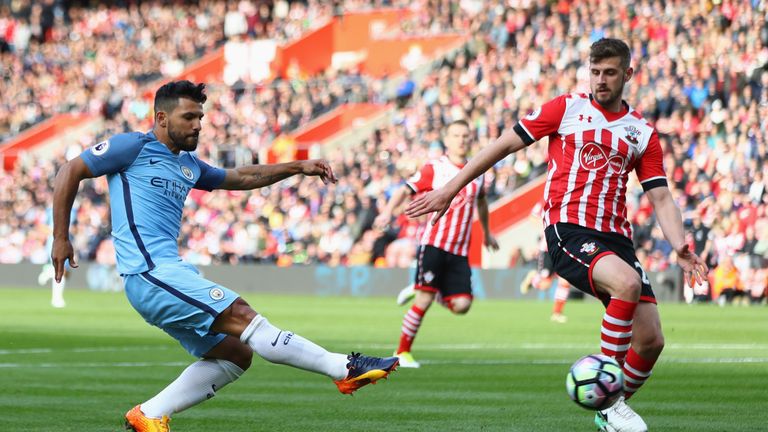 Sergio Aguero shoots as Jack Stephens attempts to block during the match  St Mary's