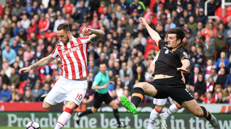 Marko Arnautovic scores for Stoke City as Harry Maguire attempts to block his shot