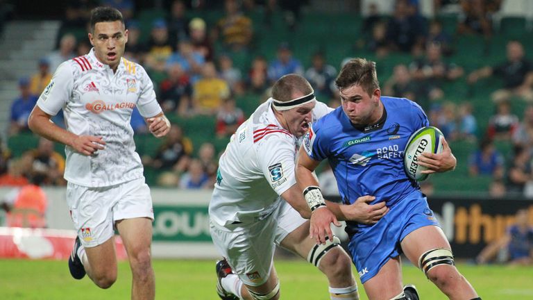 Richard Hardwick of the Force is tackled by Brodie Retallick of the Chiefs