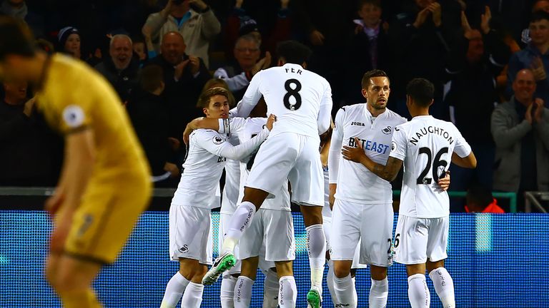 Swansea City's players celebrate after taking a 1-0 lead at the Liberty Stadium