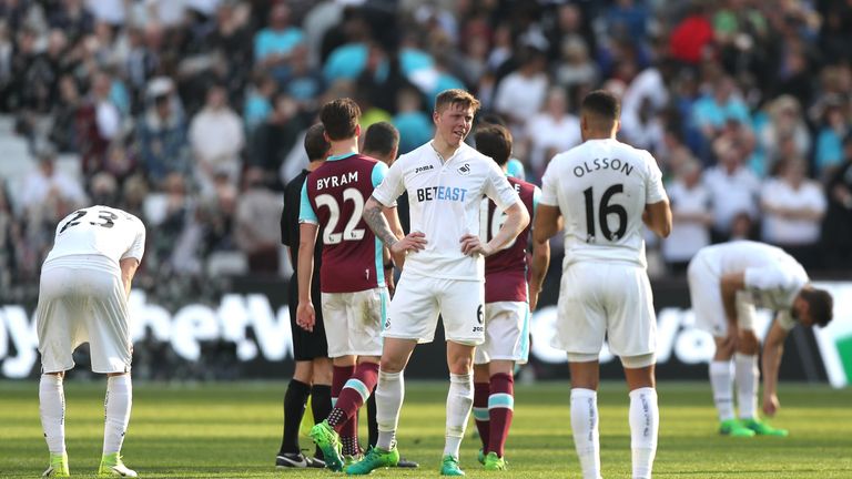STRATFORD, ENGLAND - APRIL 08: Alfie Mawson of Swansea City is dejected after the Premier League match between West Ham United and Swansea City at London S