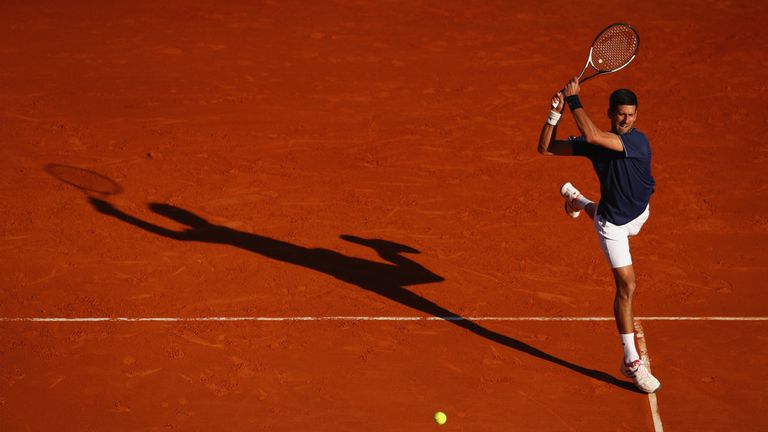 Novak Djokovic of Serbia plays a  backhand against Pablo Carreno Busta of Spain in his third round match