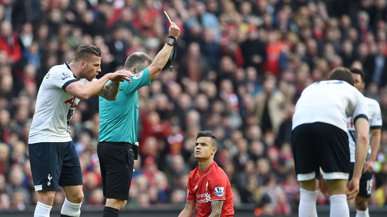 Liverpool's Brazilian midfielder Philippe Coutinho is booked by referee Jon Moss for diving after a challenge with Tottenham Hotspur's Toby Alderweireld