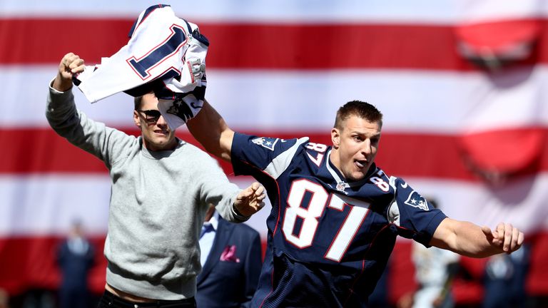 Rob Gronkowski of the New England Patriots steals Tom Brady's jersey ahead of Monday's Boston Red Sox game