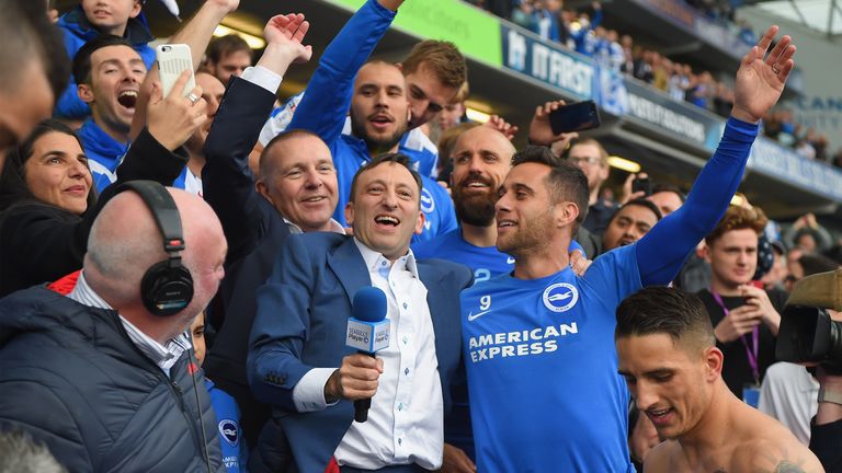 BRIGHTON, ENGLAND - APRIL 17:  Brighton chairman Tony Bloom (with microphone) celebrates with players at the end of the Sky Bet Championship match between 