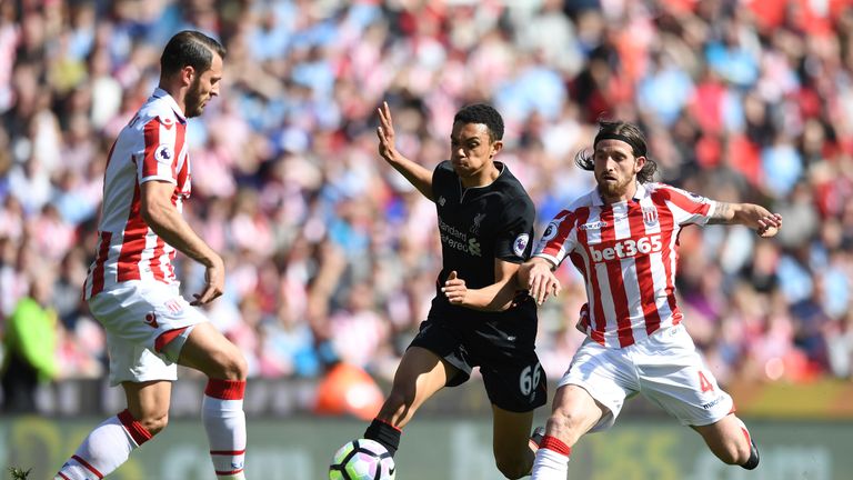 STOKE ON TRENT, ENGLAND - APRIL 08: Trent Alex Arnold of Liverpool (L) and Joe Allen of Stoke City (R) battle for possession during the Premier League matc