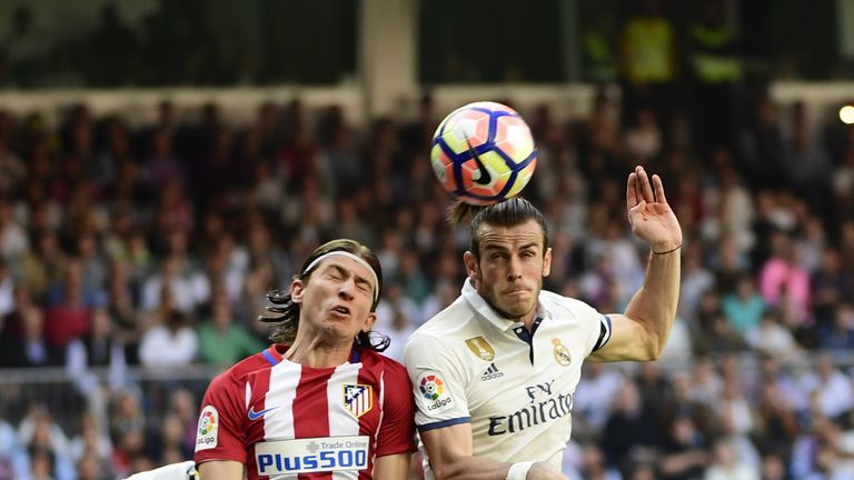 Atletico Madrid's Brazilian defender Filipe Luis (L) heads a ball with Real Madrid's Welsh forward Gareth Bale  during the Spanish league football match Re
