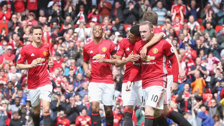 Wayne Rooney is congratulated by his Manchester United team-mates after scoring a penalty against Swansea
