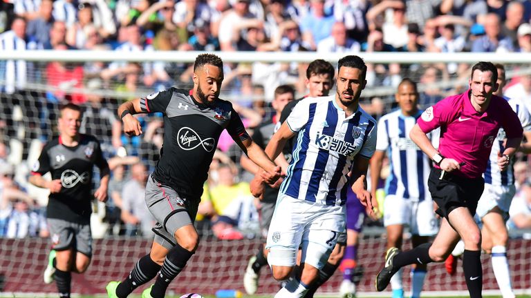 WEST BROMWICH, ENGLAND - APRIL 08: Nathan Redmond of Southampton (L) takes the ball past Nacer Chadli of West Bromwich Albion (R) during the Premier League