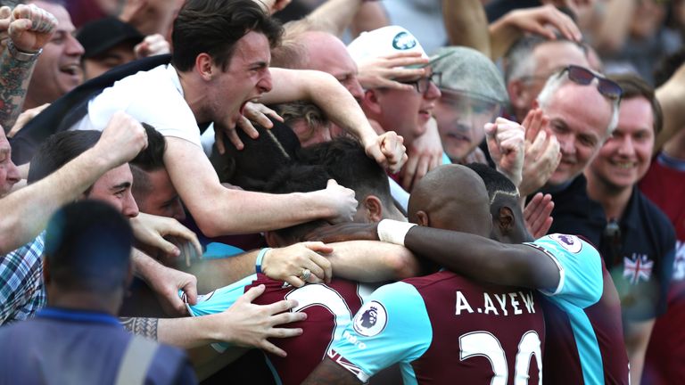 STRATFORD, ENGLAND - APRIL 08:  Cheikhou Kouyate of West Ham United (obscure) celebrates scoring his sides first goal with his team mates and West Ham Unit
